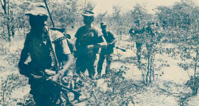 South African troops on patrol near Angolan border. Note patrol formation , with machine gunner up front carrying radio. (point man not shown), patrol leader, and FN rifleman with contact-breaking rifle grenade attached and ready for counter-ambush action. Machine gun is FN-MAG. 