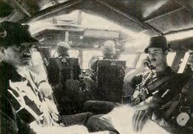 Inside South African "Hippo" armored personnel carrier. Vehicle, reinforced against landmines. has twin Browning machine guns, controlled by man upfront, left. Driver is on right, with radio handled by second man on right. Glass is .30 caliber bullet-proof. 