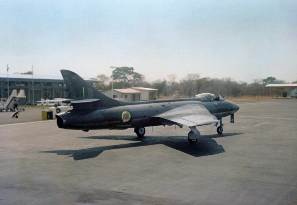 Sqn Ldr Rob Gaunt taxies Hunter FGA9 R1258, wearing the attractive new green-and-white roundels, past the terminal building at Victoria Falls while on stand-by to attack an incursion across the Zambezi