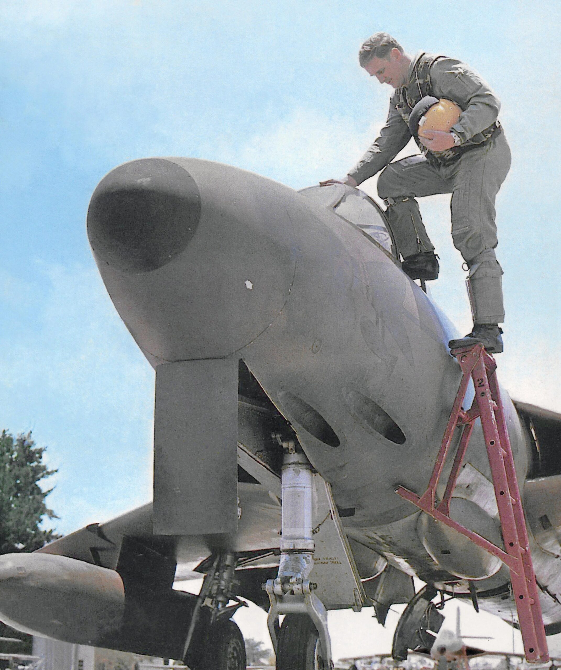 Sqn Ldr Rich Brand climbs into Hunter R1284, which, although officially devoid of all markings, wears a stylised bomb-carrying eagle in camouflage colours under the cockpit.