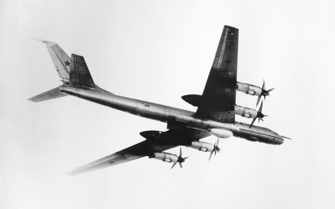 An air-to-air right side view of a Tu-142 Bear F anti-submarine patrol aircraft.